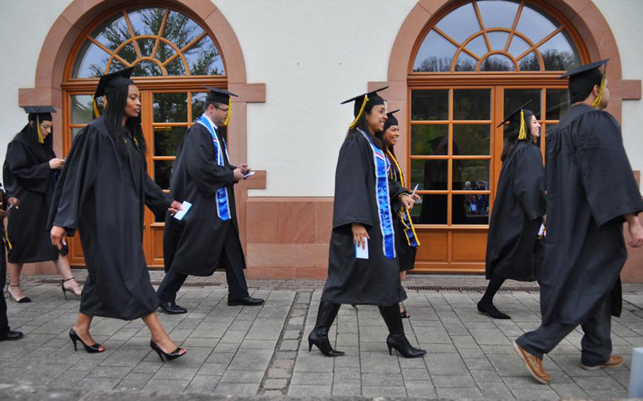 Graduates walk in a procession before the commencement ceremony on Saturday, April 30, 2016, for the University of Maryland University College in Kaiserslautern, Germany.