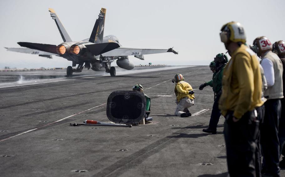The flight deck crew onboard the aircraft carrier USS Harry S. Truman watch as an F/A 18 Super Hornet launches April 25, 2016. The Truman carrier strike group has been extended 30 days to support operations against terrorist networks in the Middle East including the Islamic State in Iraq and Syria.