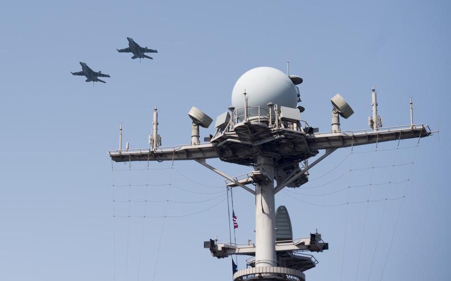 U.S. Navy jets fly by the aircraft carrier USS Harry S. Truman April 25, 2016.
