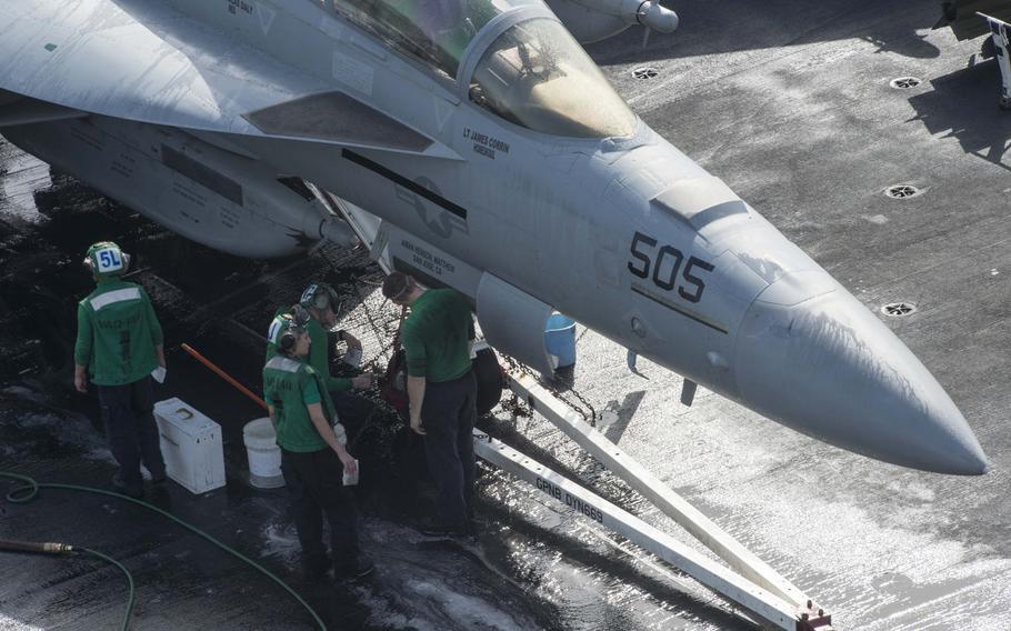 Flight deck crew aboard the USS Harry S. Truman wash an aircraft April 26, 2016.