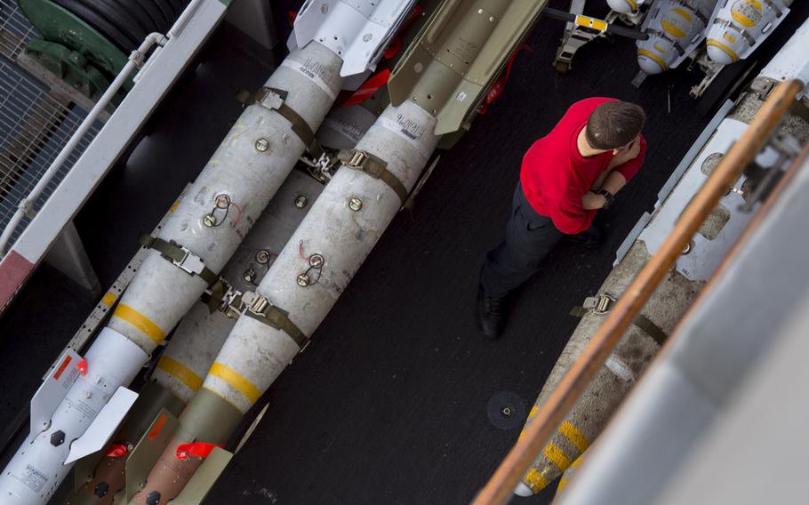 An aviation ordnanceman aboard the aircraft carrier USS Harry S. Truman waits by ordnance April 26, 2016. The Truman carrier strike group has been extended 30 days to support operations against terrorist networks in the Middle East including the Islamic State in Iraq and Syria.