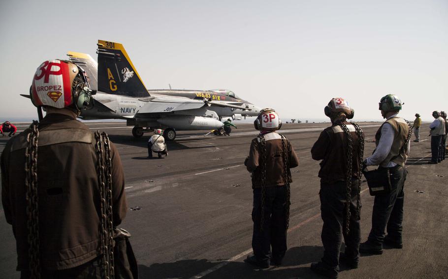 Air wing plane captains and other flight deck crew prepare for an F/A 18 Super Hornet launch aboard the aircraft carrier USS Harry S. Truman April 25, 2016.