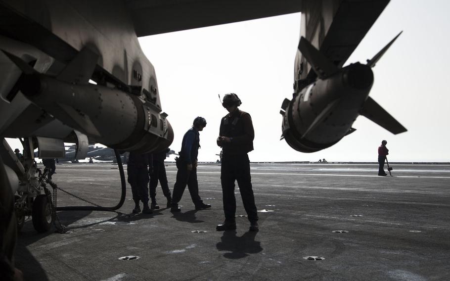 An air wing plane captain walks around an aircraft conducting a spot check aboard the USS Harry S. Truman April 25, 2016. The Truman carrier strike group has been extended 30 days to support operations against terrorist networks in the Middle East including the Islamic State in Iraq and Syria.