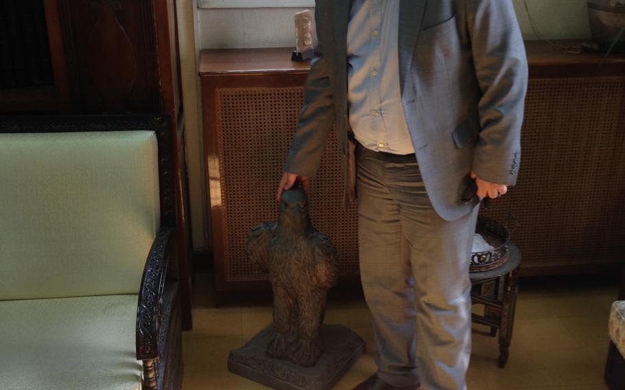 Prof. Dr. Maamoun Abdulkarim, Syria's General Director of Antiquities and Museums, pats a fake "Maltese Falcon" in his office on April 23, 2016. Many of the artifacts being smuggled out of Syria for sale to Western collectors include fakes like this one, he said.