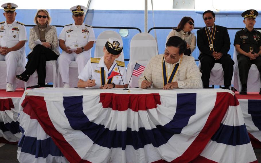 Vice Adm. Nora Tyson, left, 3rd Fleet commander, and Leo Herrera-Lim, Philippine Consul General in Los Angeles, sign documents transferring ownership of R/V Melville to the Philippine Navy during a ceremony April 27, 2016, at Naval Base San Diego, where it was commissioned as the BRP Gregorio Velasquez. The ship is now on its way to the Philippines via Hawaii and Guam.