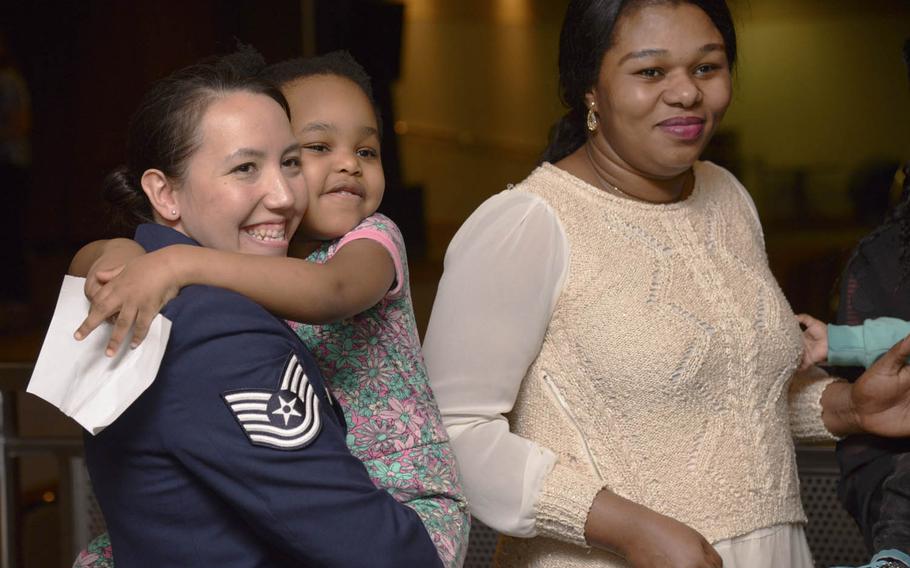 Tech. Sgt. Tina Kay of the 607th Weather Squadron hugs the daughter of Precious Enyioko, right, after the Songtan fire-rescue recognition ceremony at Osan Air Base, South Korea, Friday, May 13, 2016. Kay was credited with keeping the family safe and administering first aid after the rescue of Enyioko and three of her children from a burning building on April 29, 2016.