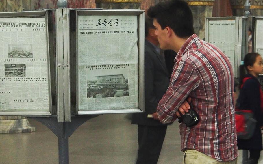 A tourist reads the state-run Rodong Sinmun newspaper at Yonggwang Metro Station in Pyongyang, North Korea. The U.S. State Department has issued a strongly worded and unusually detailed warning advising Americans not to visit North Korea, pointing to rising tensions on the divided peninsula and the detention of several foreigners in recent years.