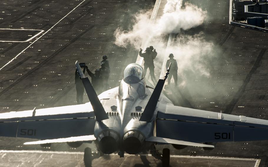 Sailors direct an EA-18G Growler, assigned to the ''Patriots'' of Electronic Attack Squadron 140, on the flight deck of aircraft carrier USS Harry S. Truman Nov. 16, 2015. The military uses the Growler to disrupt the enemy's communications.