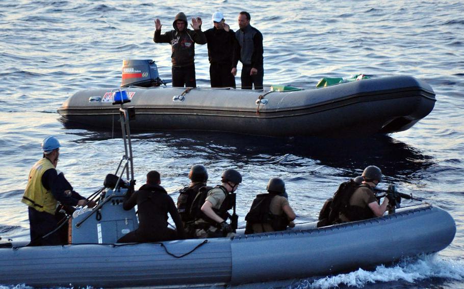 In a 2010 file photo, three suspected drug smugglers agree to a consensual boarding of their ridged hull inflatable boat by U.S. sailors during routine operations by the USS Elrod in the Western Mediterranean Sea. Now, U.S. ships will join the effort in the Aegean Sea against a different type of smuggling, of migrants.