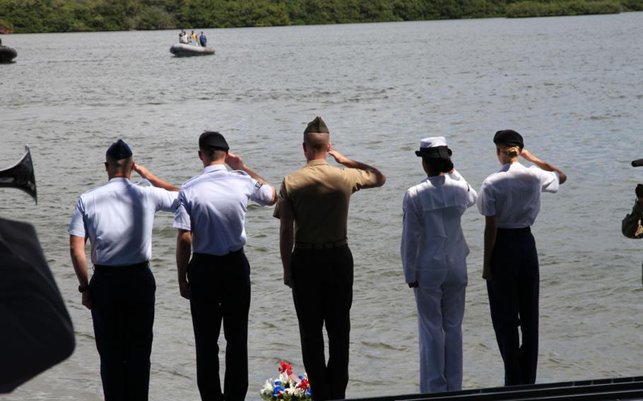 Representatives of each service salute while taps is played aboard the LTG William B. Bunker in Pearl Harbor, May 20, 2016, during a ceremony commemorating the West Loch disaster of 1944.