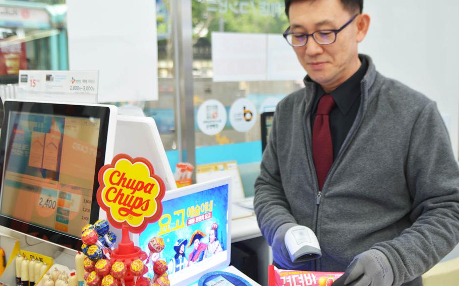 Ho Young Kang rings up a Gyeondyo-bar at his Withme convenience store in Seoul. Marketed as a hangover remedy, the ice cream bar hit the shelves last week and is the latest in a series of purported hangover cures in a country that has some of the heaviest drinkers in the world.