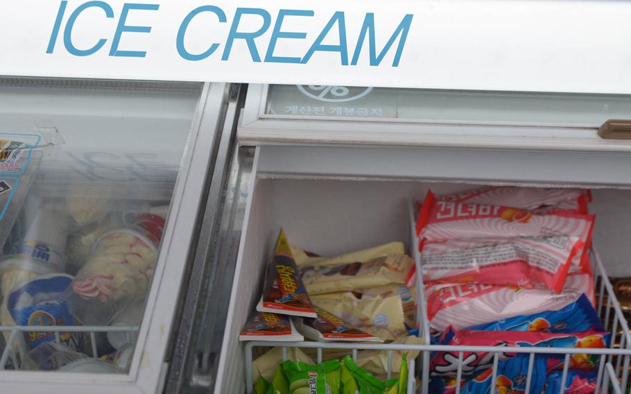 An ice cream bin holds Gyeondyo-bars, in the pink and white wrapper, at a convenience store in Seoul. The Withme convenience store chain introduced the hangover-fighting dessert last week.