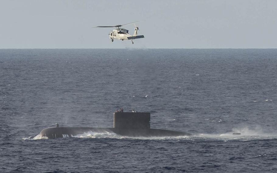 An MH-60S assigned to the Blackjacks of Helicopter Sea Combat Squadron 21 performs the medical evacuation of a sailor from the South Korean submarine SSK Lee Eok Gi to hospital ship USNS Mercy, Friday, May 27, 2016. Mercy is deployed in support of Pacific Partnership 2016.