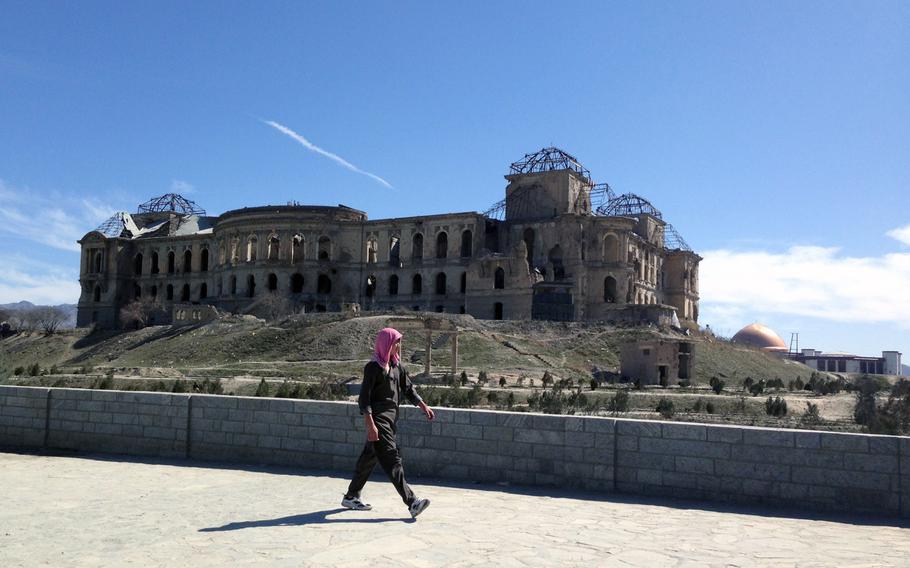 A pedestrian passes the remnants of Kabul's Darul Aman Palace earlier this year. On Monday, May 30, 2016, Afghan President Ashraf Ghani inaugurated a project to restore the palace, built nearly 100 years ago to house the national parliament. The building was destroyed in the 1990s during Afghanistan's civil war.