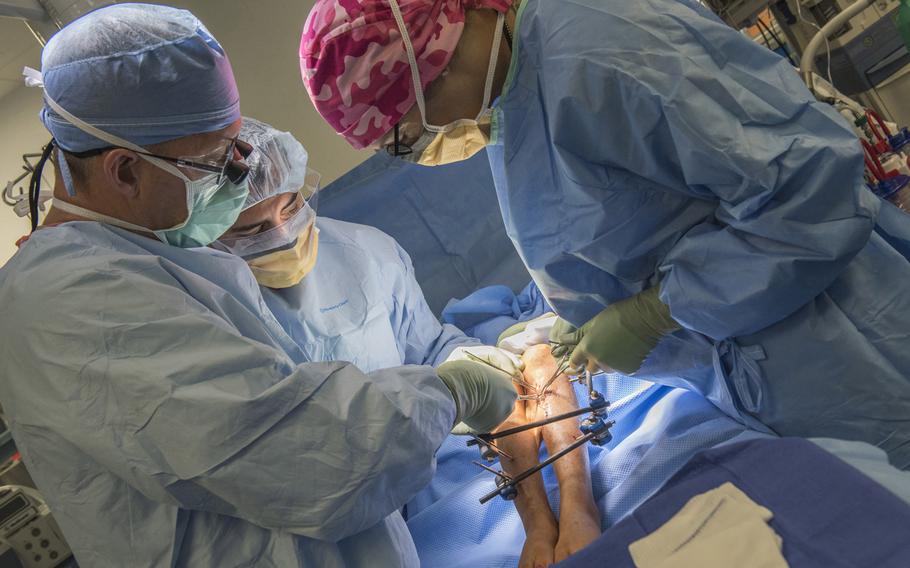 Surgeons work together to save the leg of an Afghan patient, June 10, 2016 at Craig-Joint Theater Hospital, Bagram Airfield, Afghanistan. Multiple surgeons from different specialties have come together in an effort to repair the patient?s leg after suffering a gun-shot wound that threatened to take her leg.