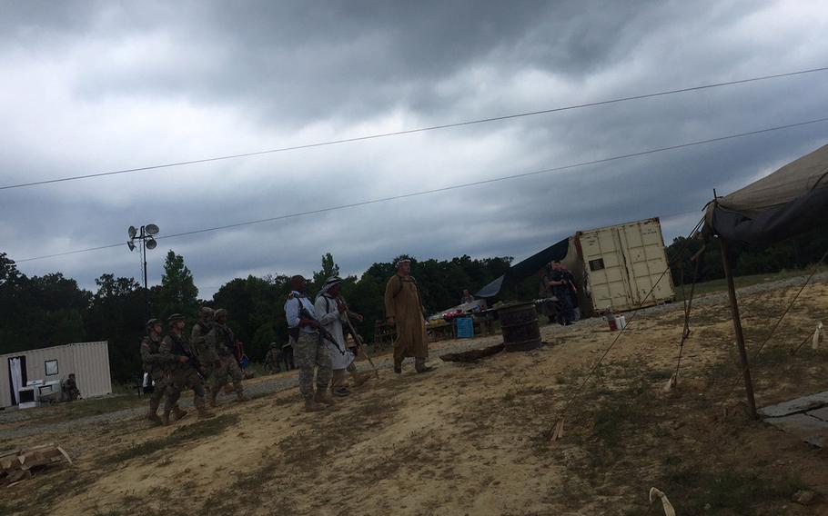 The U.S. Army Cadet Command at Fort Knox, Ky., runs about 6,000 Reserve Officer Training Corps cadets through its 30-day required summer drills each year. This year, for the first time, it's putting the cadets through a 13-day field exercise in the simulated war-torn village of "Ashaghi." The cadets are in the role of U.S. forces who just arrived to help preserve the peace. Local village leaders and opposing forces are played by soldiers from U.S. Forces Command, and the test the cadets in real-world scenarios such as village shura security meetings, dealing with insurgencies and securing roads. This is the first year the cadet's training has included the real-world scenarios as their field exercise. Soldiers from U.S. Forces Command run the village all summer, and move in several weeks before the cadets arrive. They live in the container buildings, and will react to the cadets depending on how they perform in each day's scenario.