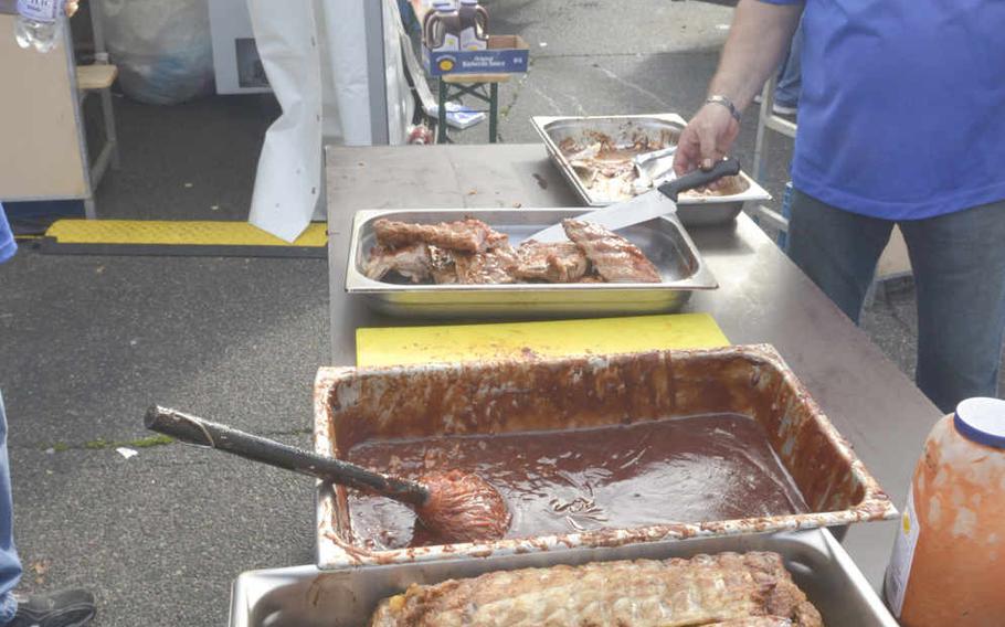 U.S. Army Garrison Morale, Welfare and Recreation business manager Mark Smith prepares barbecue ribs at the German-American Friendship Festival, Sunday, July 3, 2016 in Wiesbaden. Thousands of locals and Americans enjoyed food, drink and amusement rides at the event, set to conclude on Independence Day Monday. Dan Stoutamire/Stars and Stripes