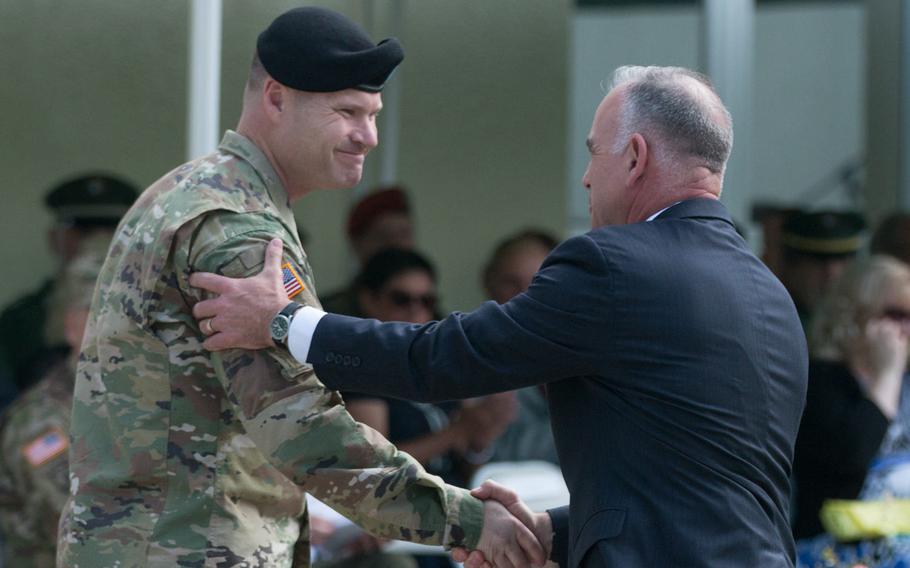 Col. Lance Varney, left, shakes hands with Michael Formica, director of Installation Management Command Europe during Varney's assumption-of-command ceremony at Grafenwoehr, Germany, on Tuesday, July 5, 2016.