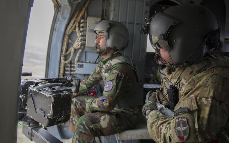 Master Sgt. Justin Kay, Train Advise Assist Command - Air Mi-17 flight engineer, right, provides overwatch from the door of an Mi-17 helicopter during a training mission on March 3, 2016. NATO is set - at a summit in Warsaw, Poland, this week - to commit to continue its support of government forces in Afghanistan.