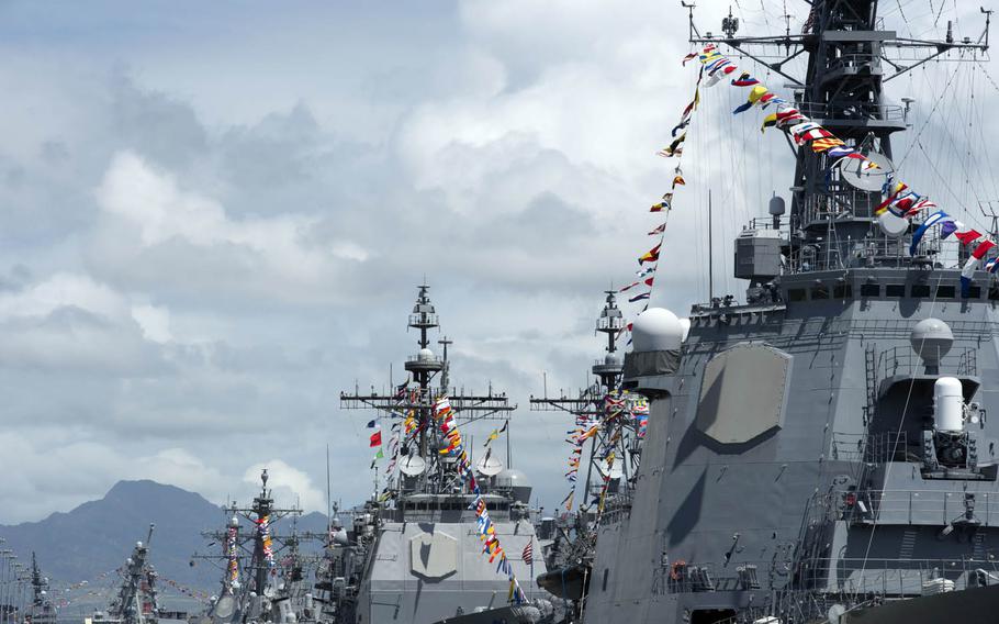 Ships moored at Joint Base Pearl Harbor-Hickam, Hawaii, display maritime signal pennants and flags from their masts during Rim of the Pacific 2016 on Monday, July 4, 2016. Twenty-six nations, more than 40 ships and submarines, more than 200 aircraft and 25,000 personnel are participating in RIMPAC through Aug. 4 in and around the Hawaiian Islands and Southern California.