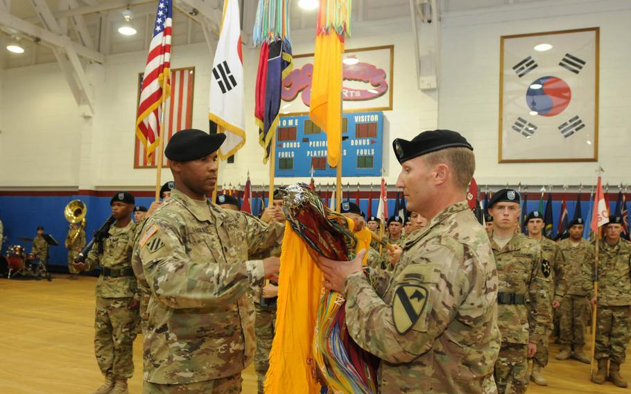 Col. Patrick A. Douglas, left, battalion commander of the 2nd Battalion, 8th Cavalry Regiment, and Command Sgt. Maj. Gregg D. Larsen, senior enlisted adviser for the battalion, participate in a casing of the colors ceremony at Camp Red Cloud, South Korea, Friday, July 8, 2016.