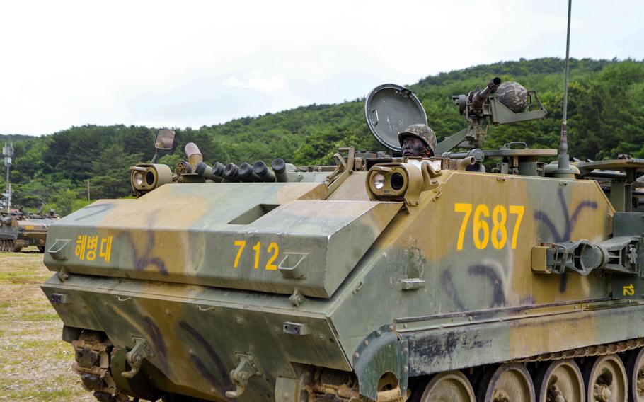 A camouflaged South Korean Marine mans his Assault Amphibious Vehicle after a joint training exercise as part of a Korean Marine Exchange Program with visiting U.S. Marines. The exercise on July 6 was the culmination of weeks of planning and rehearsals. It was held on the Suseong Range near the southeastern city of Pohang.