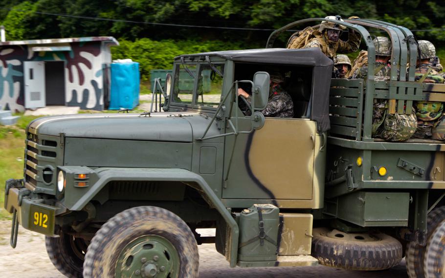 U.S. and South Korean Marine reinforcements are carried in a truck to the site of a theoretical assault as part of a Korean Marine Exchange Program with visiting U.S. Marines. They were supposed to be in a helicopter as part of an air and ground command control exercise, but the helicopter couldn't make it because of weather concerns. The exercise on July 6 was the culmination of weeks of planning and rehearsals. It was held on the Suseong Range near the southeastern city of Pohang.