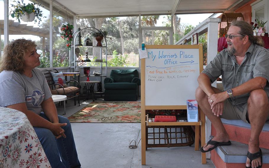 Kelly Kowall chats with a Bill Sims, a retired Navy senior chief who wandered in to volunteer his assistance on March 10. Kowall created My Warrior's Place after her son Corey was killed in action in Afghanistan in 2009.