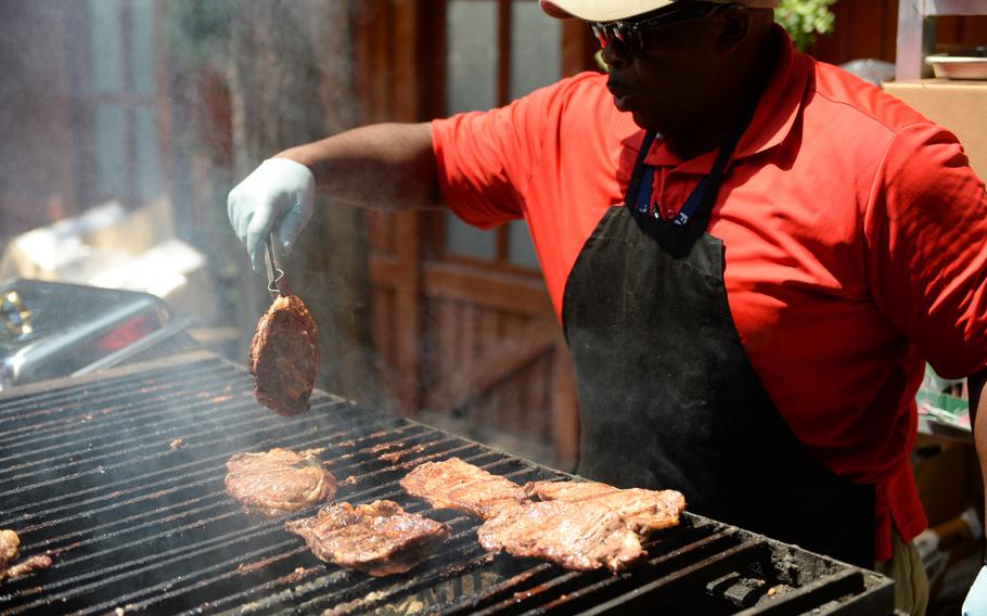 Dining facility supervisor Vince Drennen barbeques meat at Resolute Support's U.S. Independence Day celebration on July 8, 2016.