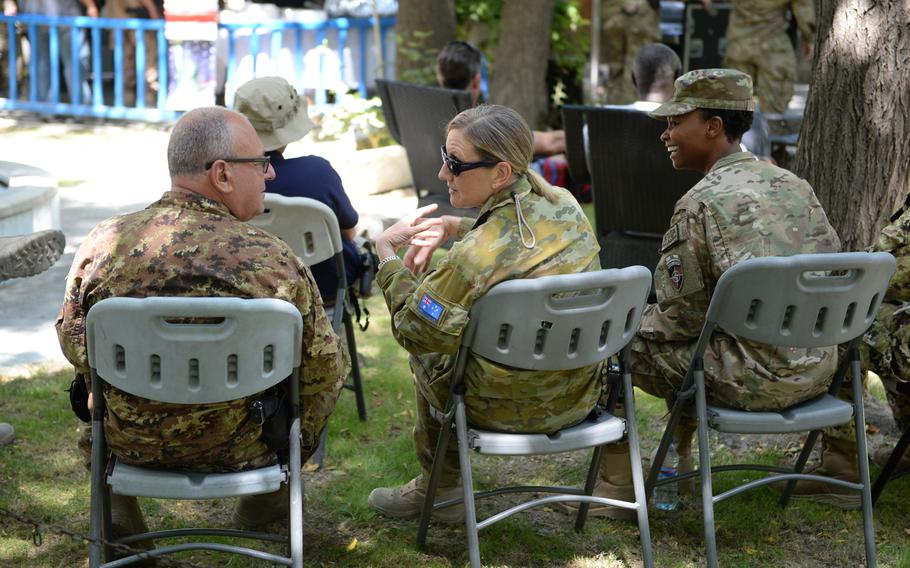 Col. S. Tagliata of Italy, left, Wing Commander W. Gill of Australia and American Capt. A. Lockett share a laugh at Resolute Support's U.S. Independence Day celebration on Friday, July 8, 2016.