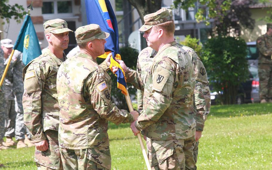 Maj. Gen. Duane Gamble, right, commander of the 21st Theater Sustainment Command, passes the 7th Mission Support Command guidon to Brig. Gen. Steven Ainsworth during the change of command ceremony on Saturday, July 9, 2016, in Kaiserslautern, Germany.