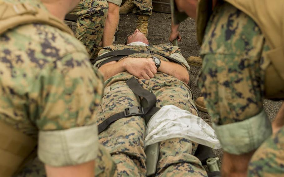 Marines with Marine Wing Support Squadron 171 prepare to lift a simulated victim to safety during Eagle Wrath 2016 at Combined Arms Training Center Camp Fuji, Japan, Friday, July 8, 2016. The squadron plans to complete its unit annual training requirements throughout three stages that focus on air base ground defense and common skills that Marines are unable to train for locally.