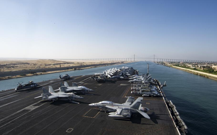 The aircraft carrier USS Dwight D. Eisenhower approaches the Friendship Bridge as it transits the Suez Canal. The Eisenhower moved into the 5th Fleet area of responsibility after concluding operations in the Mediterranean Sea on July 7.
