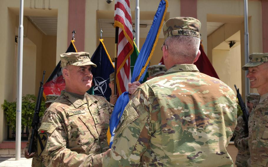 Maj. Gen. Richard Kaiser, incoming commander of Combined Security Transition Command - Afghanistan, accepts the guidon from Gen. John Nicholson, commander of U.S. and NATO forces in Afghanistan during a change-of-command ceremony in Kabul, Afghanistan, on Thursday, July 14, 2016.