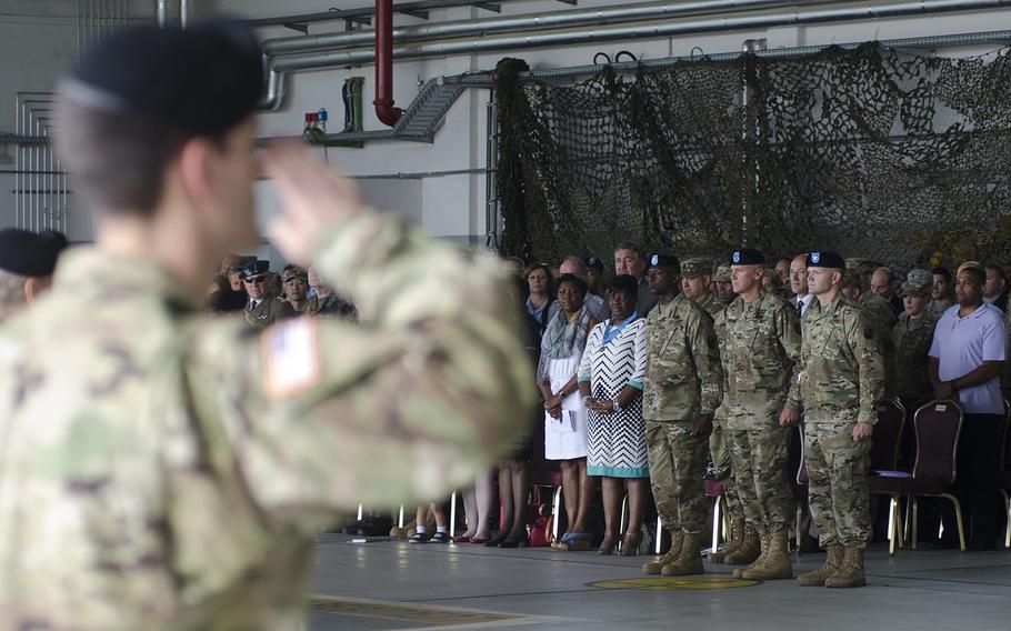 A soldier salutes during the 5th Signal Command change-of-command ceremony July 15, 2016, at Clay Kaserne in Wiesbaden, Germany. Col. Jimmy L. Hall, center left, handed over responsibility for the command to Col. Rob Parker, center right.