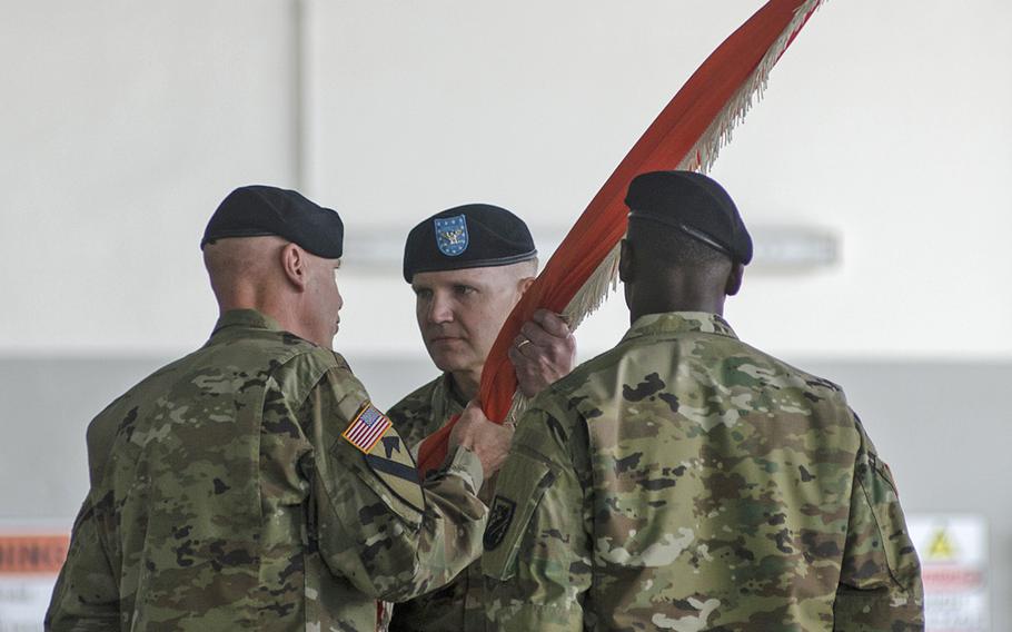 Col. Rob Parker, center, takes the colors of the 5th Signal Command from Maj. Gen. John B. Morrison, Jr., commander of U.S. Army Network Enterprise Technology Command, during a change-of-command ceremony on July 15, 2016, at Clay Kaserne in Wiesbaden, Germany. Parker will serve as the command's 22nd commander since its activation in 1974.