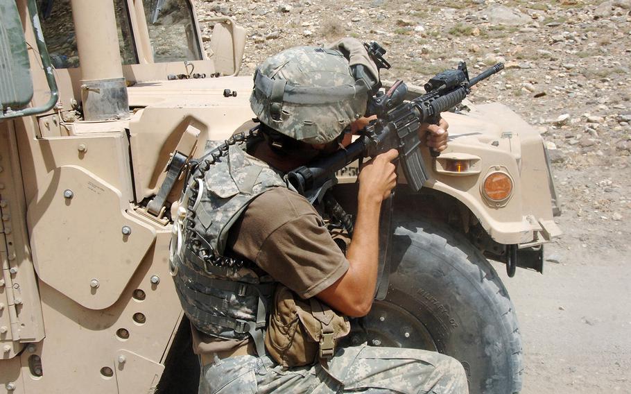 Staff Sgt. Jason Geranen, of F Company, 2nd Battalion, 82nd Aviation Brigade (Long Range Surveillance Detachment), engages a Taliban fighting positions near the village of Allah Say, Afghanistan.