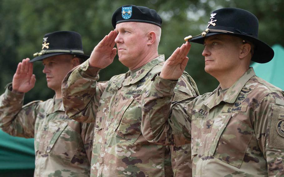 Col. Patrick Ellis, right, assumed command of the 2nd Cavalry Regiment during a ceremony held at Rose Barracks in Vilseck, Germany, on Friday, July 15, 2016. The regiment?s outgoing commander, Col. John Meyer, left, and Maj. Gen. Timothy McGuire, U.S. Army Europe?s deputy commander, render a salute during the ceremony. Michael S. Darnell/Stars and Stripes