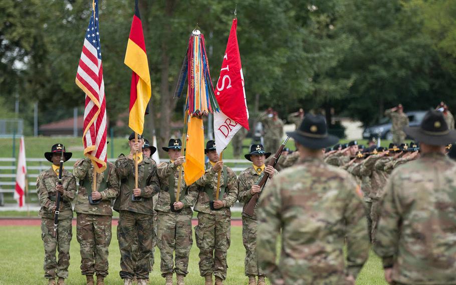 A joint color guard, made up of German and American soldiers, presents the colors and 2nd Cavalry Regiment battle flag during the change-of-command ceremony held at Rose Barracks in Vilseck, Germany, on Friday, July 15, 2016. Michael S. Darnell/Stars and Stripes