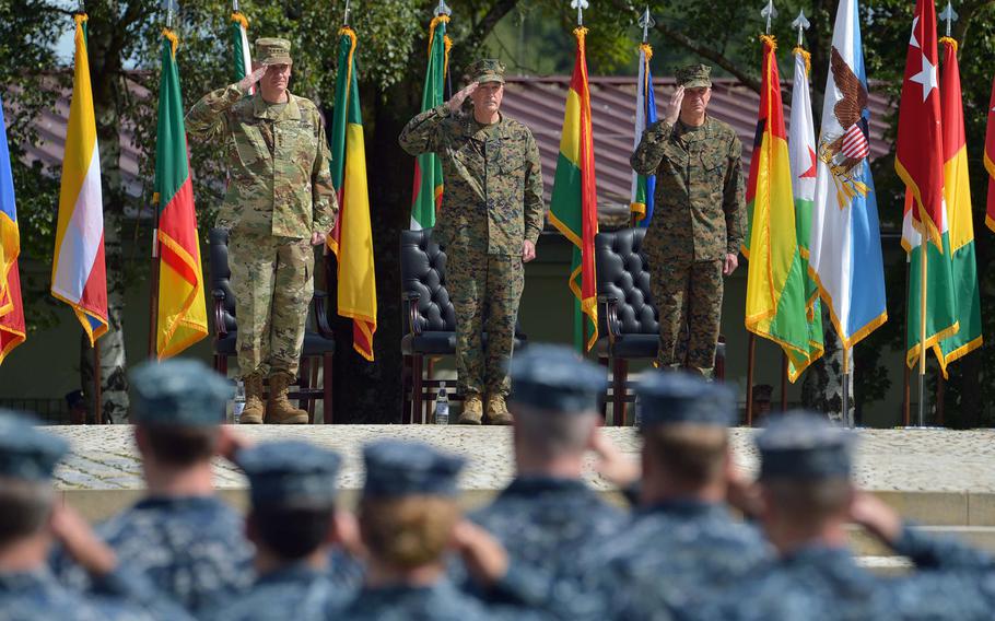 Gen. David M. Rodriguez, outgoing commander of U.S. Africa Command, left, Gen. Joseph F. Dunford, chairman of the Joint Chiefs of Staff, and incoming AFRICOM commander Gen.Thomas D. Waldhauser and troops with the command salute during the change-of-command ceremony in Stuttgart, Germany, Monday, July 18, 2016.