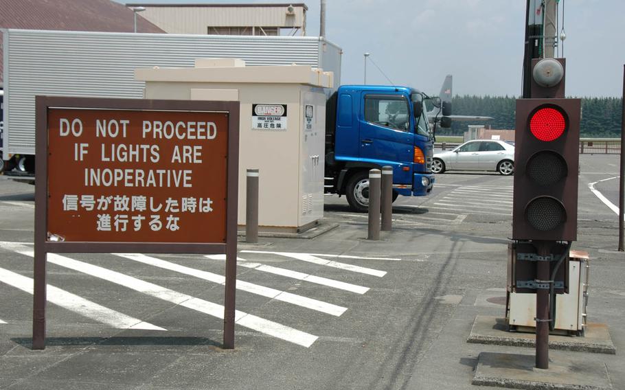 Motorists at Yokota Air Base, Japan, headquarters of U.S. Forces Japan and 5th Air Force in western Tokyo, must wait to cross the flight-line when aircraft take off and land. Drivers are also warned to watch out for jet exhaust and to yield to low-flying aircraft.