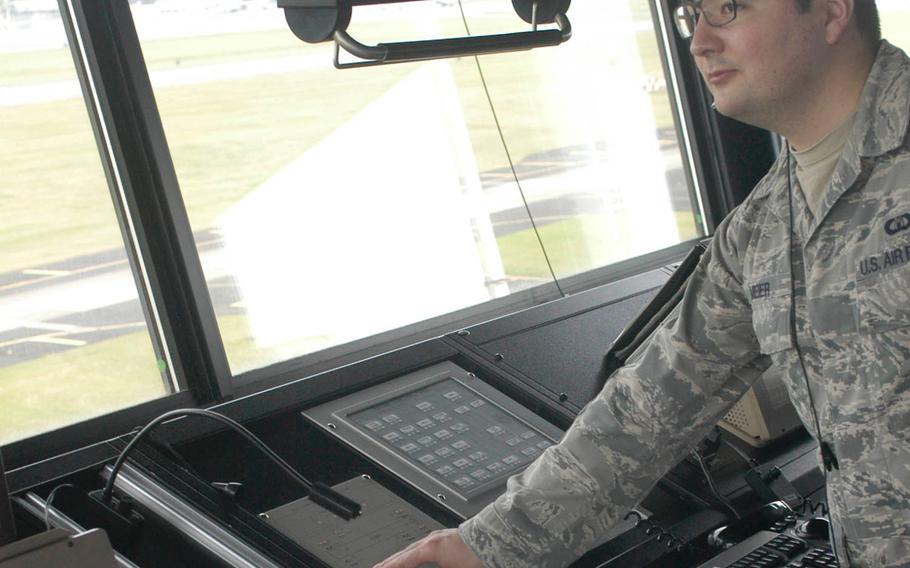 Air Force Staff Sgt. Christopher Meier engages the perimeter traffic control system, stopping cars from crossing the south end of the runway at Yokota Air Base, Japan, June 9, 2016.