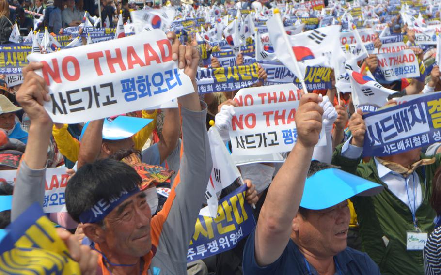 About 2,000 people rallied outside the main train station in Seoul, South Korea, Thursday, July 21, 2016. Wearing yellow capes and waving banners that said "No THAAD," they called on the government to reverse its decision to deploy the Terminal High-Altitude Area Defense system in Seongju.