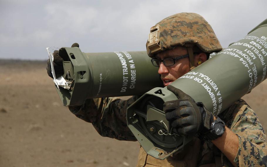 A Marine totes charge canisters for a howitzer at the live-fire range at Pohakuloa Training Area, Hawaii, July 19, 2016.