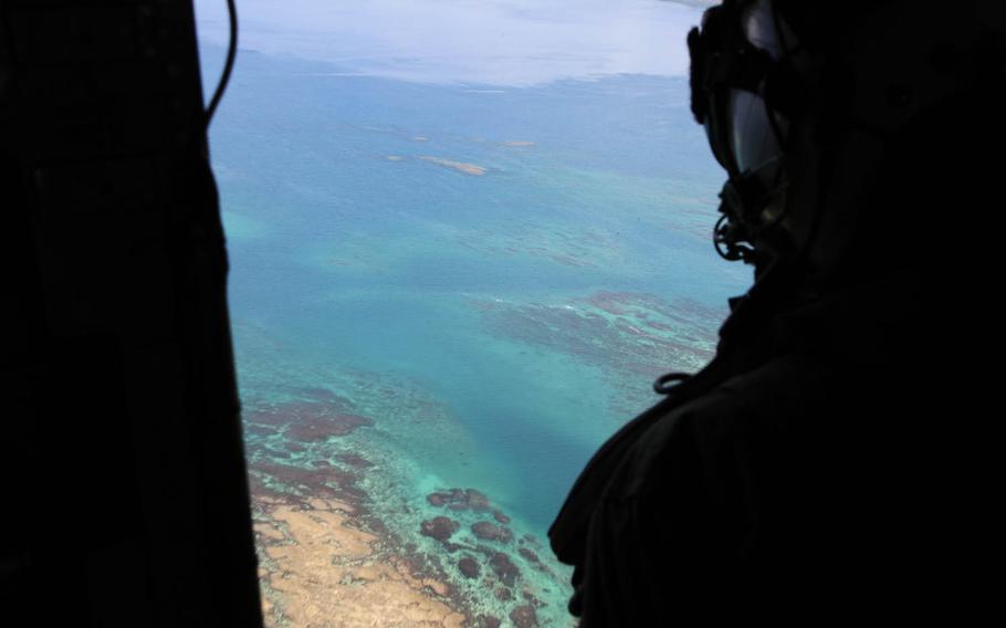 Marine Cpl. Sara Duperow, a CH-53E Super Stallion mechanic and aerial observer from Marine Heavy Helicopter Squadron 361, takes in Okinawa's stunning scenery during Japan's annual Churashima Rescue Exercise, Thursday, July 21, 2016.