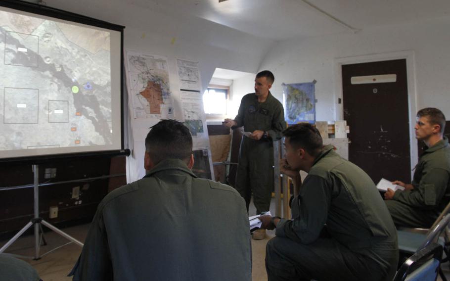 Crew members of Marine Light Attack Helicopter Squadron 367 receive an early-morning briefing on the day's raid on sites within the live-fire range of the Pohakuloa Training Area, Hawaii, July 20, 2016.