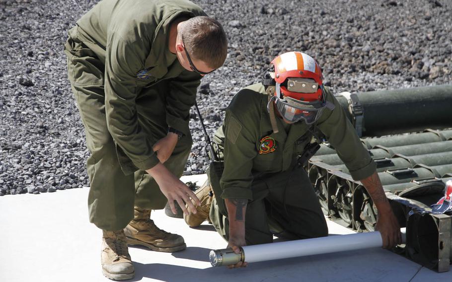 A 2.75-inch rocket is removed from a transport case at Pohakuloa Training Area, Hawaii, July 20, 2016.