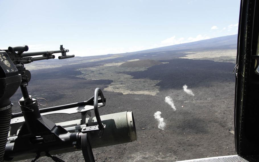 Smoke billows up from the detonation points of three 2.75-inch rockets fired from a Huey helicopter at a target below on the live-fire range of the Pohakuloa Training Area, Hawaii, July 20, 2016.