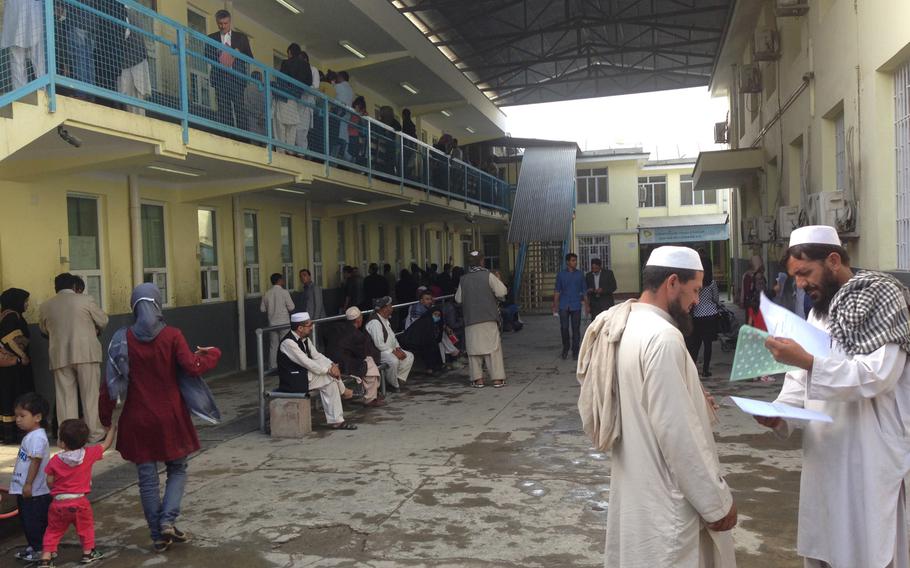Hundreds of people arrive at the passport office in Kabul, Afghanistan on Sept. 16, 2015, to apply for new travel documents. Many of them will join the thousands of Afghans, Syrians, Iraqis and other migrants seeking a new life in Germany and other European nations.