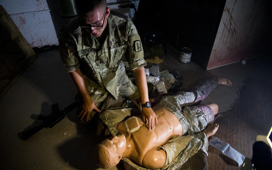 Pvt. Andrew Lepien inspects a simulated casualty during a demonstration for Ukrainian Army physicians in Baumholder, Germany, on Thursday, July 21, 2016. The demonstration was part of a medical sustainment class designed to strengthen Ukrainian military medical training abilities.
